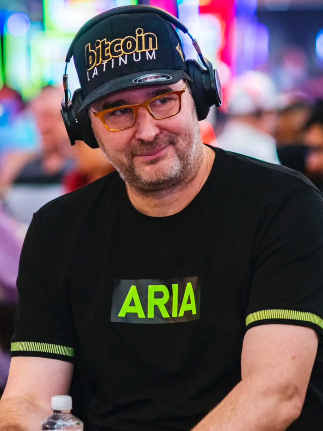 Phil Hellmuth posing in a poker-themed outfit